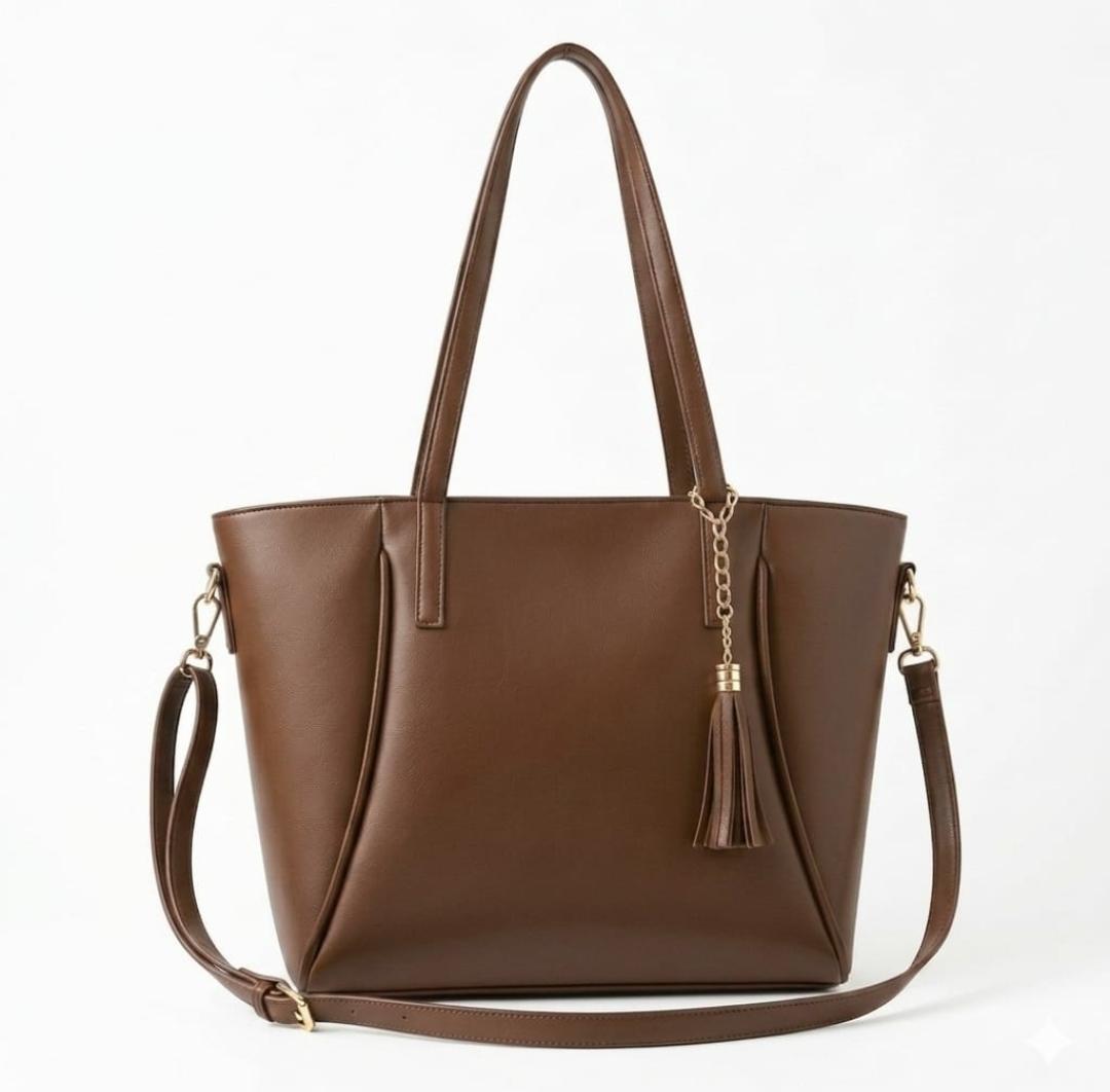 Ashir Studio tassel accent signature tote showcasing elegant jewelry design with tassel details and signature branding.