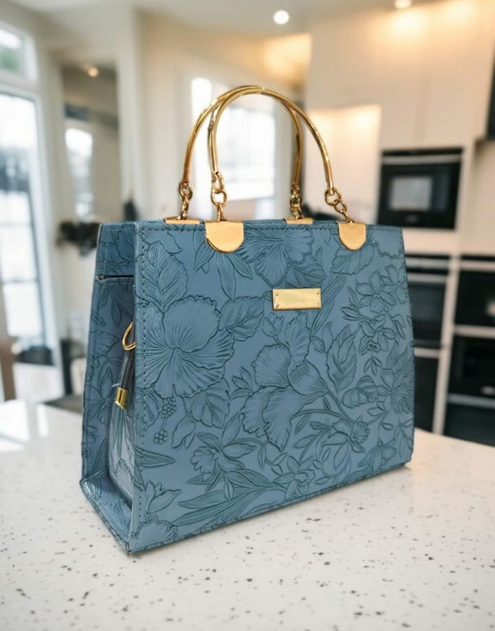 Ashir Studio floral embossed luxury tote jewelry collection displayed with intricate floral patterns on a stylish tote bag.