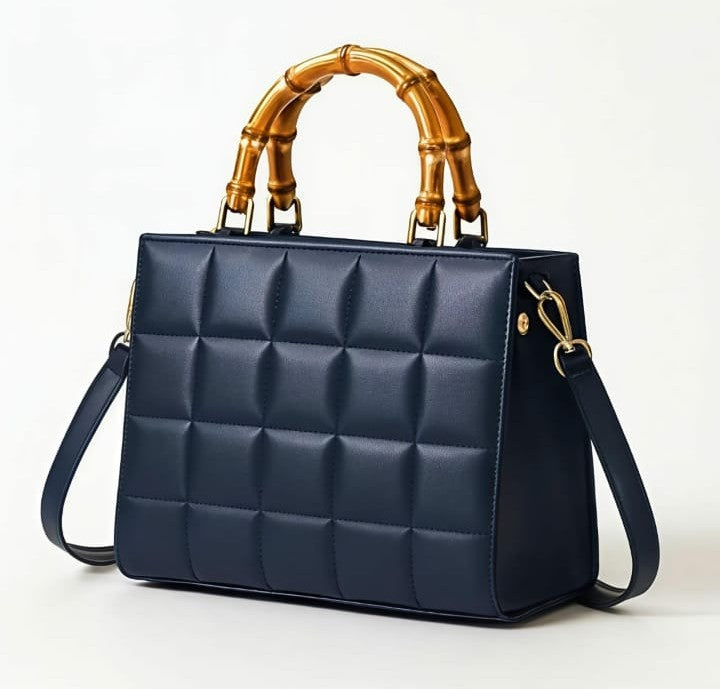 Emerald quilted handbag with bamboo handle by Ashir Studio, showcasing elegant craftsmanship and stylish design.