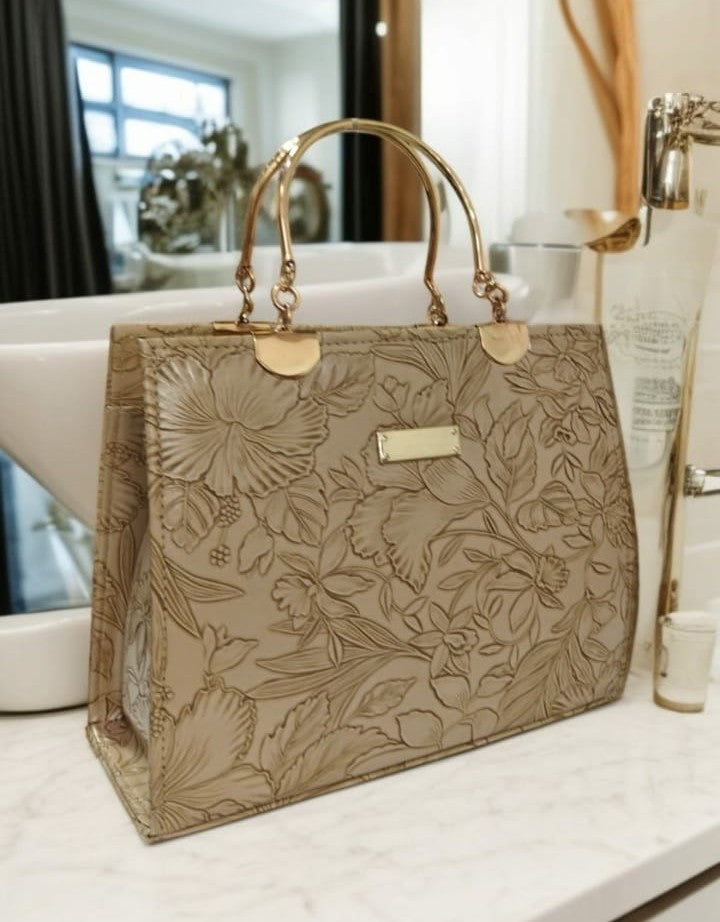 Ashir Studio floral embossed luxury tote jewelry collection with intricate floral patterns and embossed detailing.