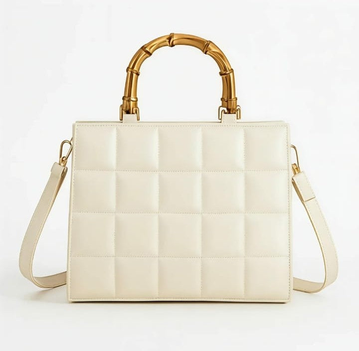 Emerald quilted handbag with bamboo handle by Ashir Studio, showcasing elegant design and textured quilting.