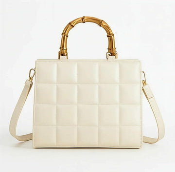 Emerald quilted handbag with bamboo handle by Ashir Studio, showcasing elegant design and textured quilting.