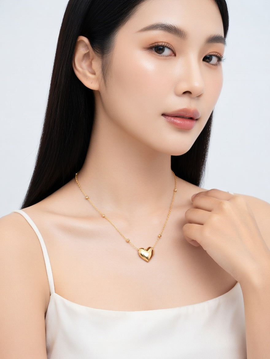Heart-shaped gold necklace from Ashir Studio, featuring a delicate pendant on a fine chain, ideal for elegant jewelry attire.