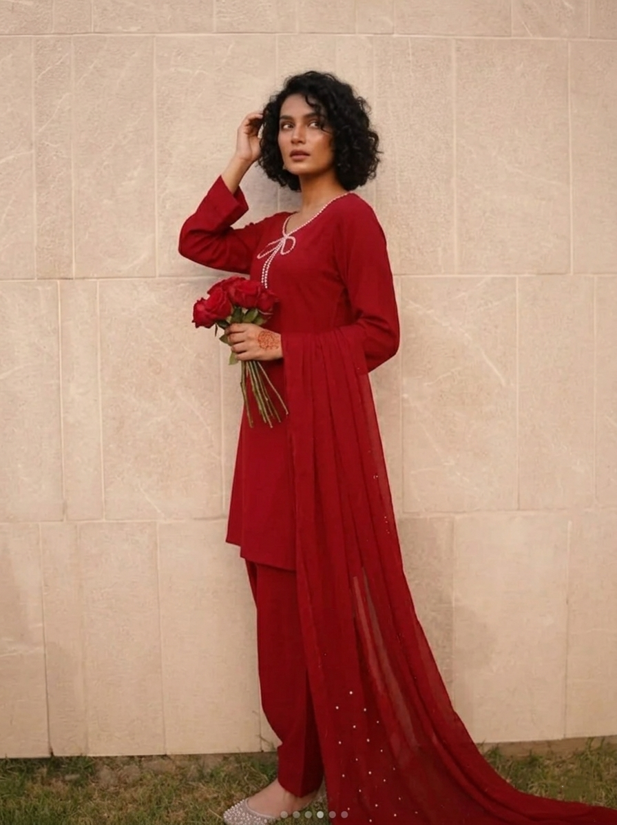 Elegant Farshi Shalwar Kameez by Ashir Studio featuring intricate embroidery and flowing fabric in vibrant colors.
