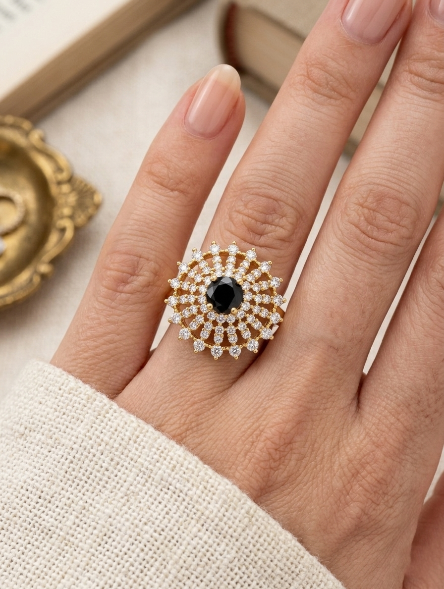 Ashir Studio Midnight Sunburst Onyx Halo Ring with 18K gold plating, showcasing a luminous black onyx center in a detailed jewelry design.