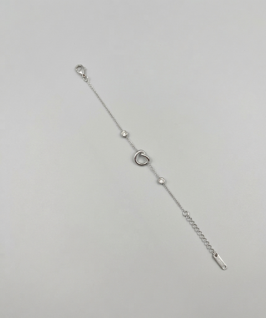 Silver-toned interlock bracelet from Ashir Studio, showcasing delicate jewelry design with intricate chain links.