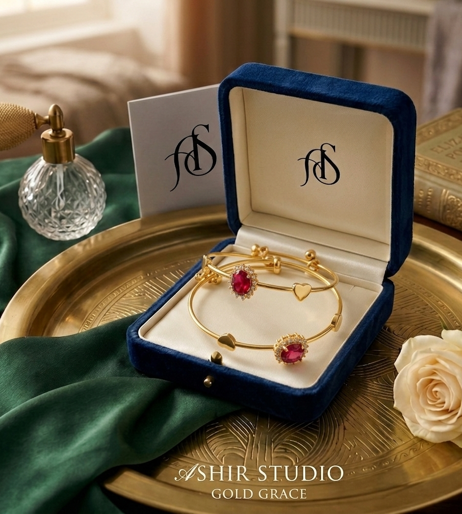 Elegant red Rubi gold bangles from Ashir Studio featuring intricate jewelry design and shiny gold finish.