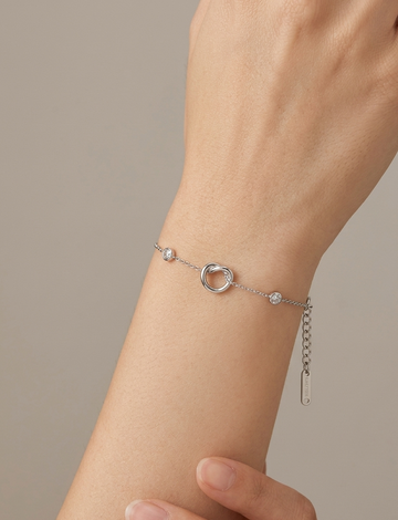 Silver-toned interlock bracelet featuring delicate jewelry design by Ashir Studio, showcasing intricate craftsmanship.