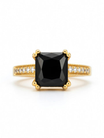 Emerald-cut black diamond halo ring in 18K yellow gold, showcasing elegant jewelry design with sparkling accents.