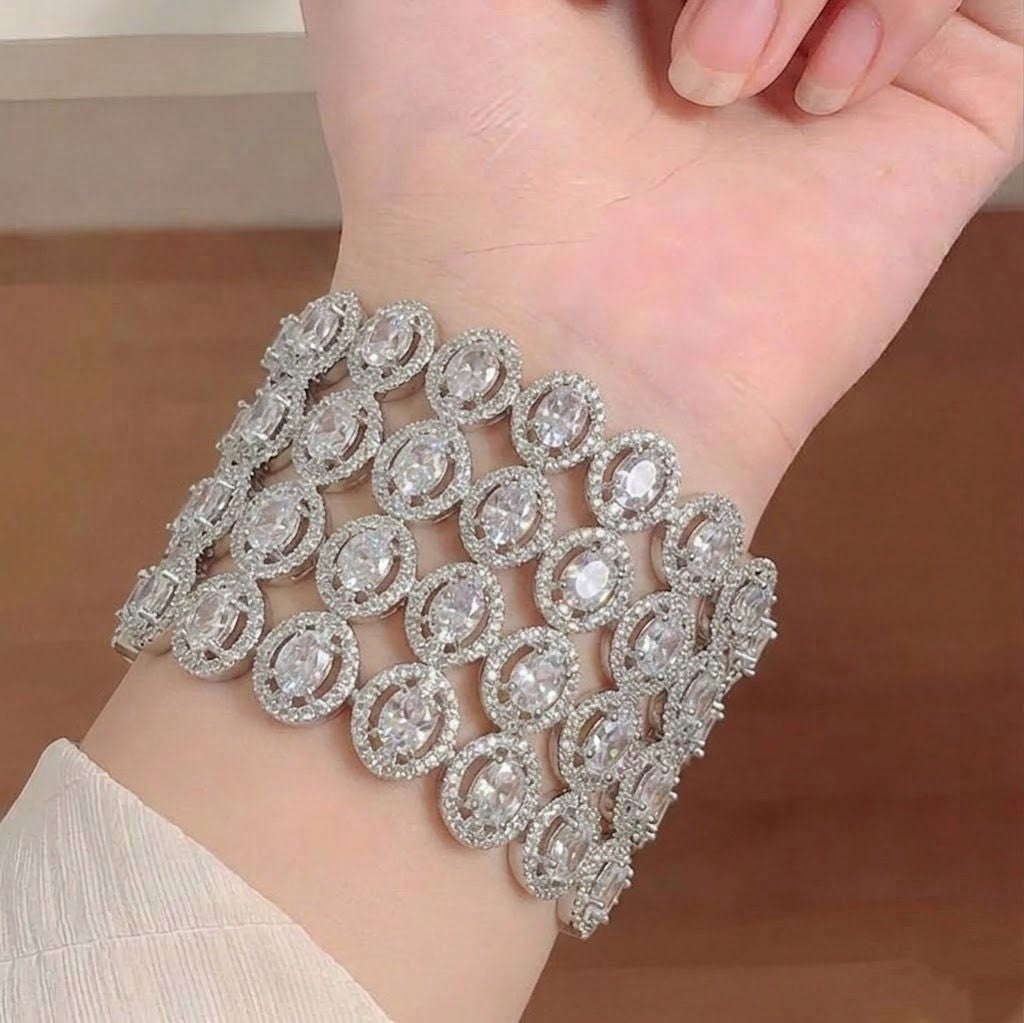 Ashir Studio American Diamond Bangles featuring sparkling diamond-style designs in a set of traditional gold-toned jewelry.