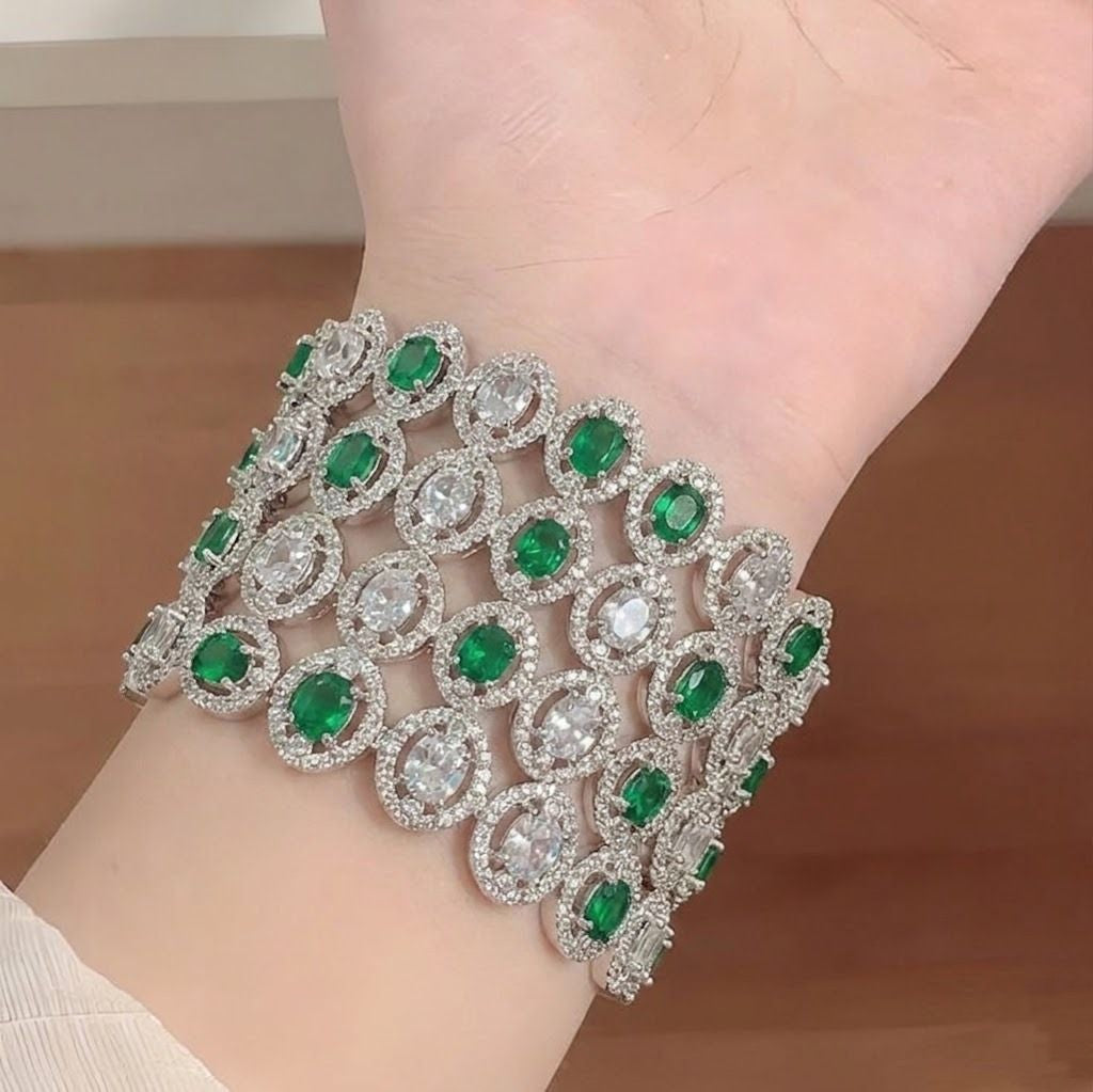 Elegant American diamond bangles from Ashir Studio, showcasing sparkling gold-toned jewelry with intricate designs.