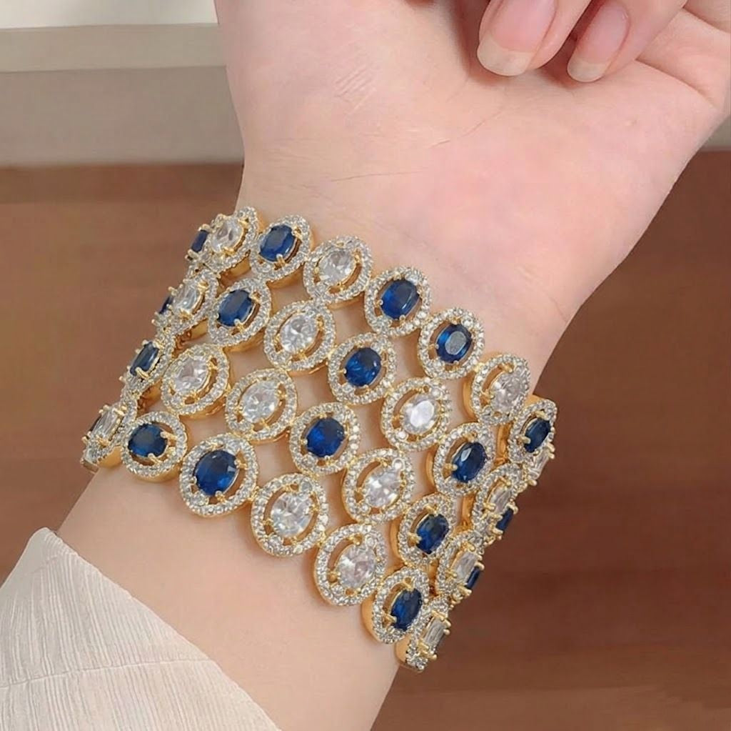 Elegant American diamond bangles from Ashir Studio featuring intricate designs and sparkling embellishments on a gold-toned bracelet.