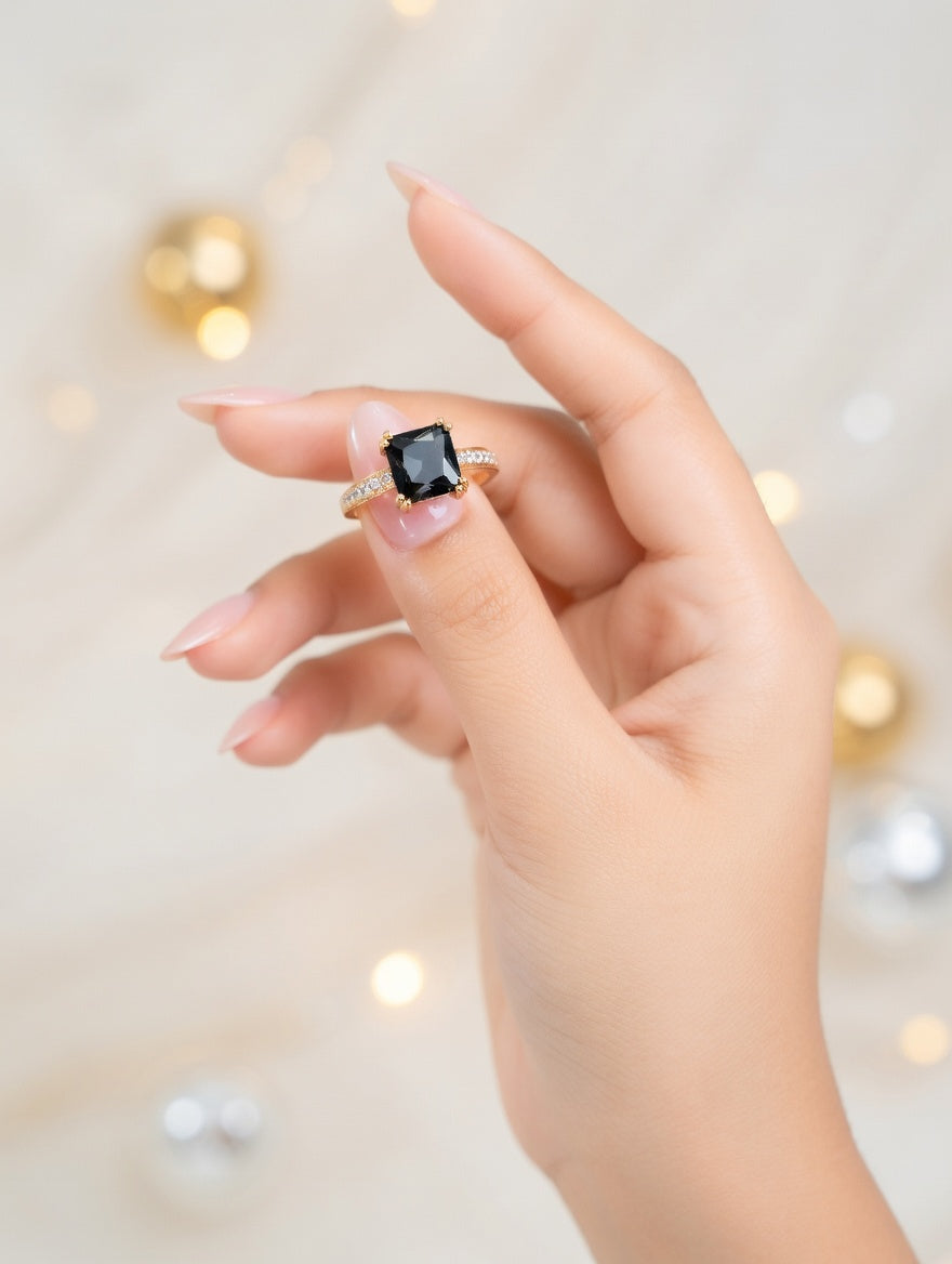 Emerald-cut black diamond halo ring in 18K yellow gold, showcasing a sleek gemstone setting and elegant jewelry design.