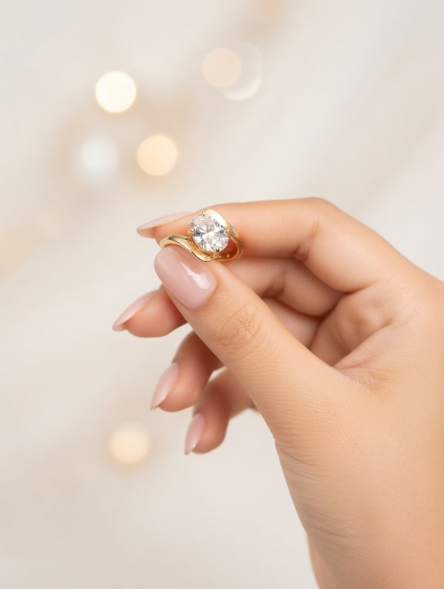 Ashir Studio Radiant Oval Solitaire Bypass Ring in 18K gold plating, featuring a shiny oval gemstone and sleek bypass design.