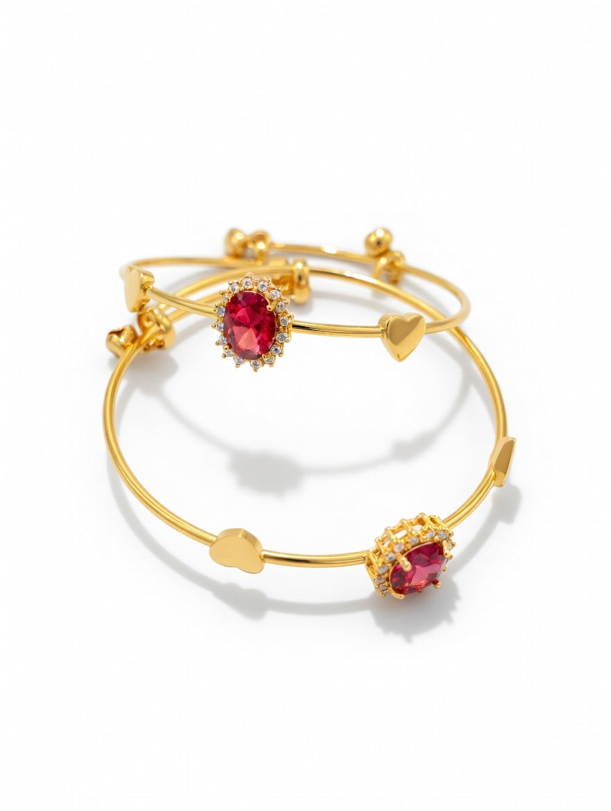 Elegant red Rubi gold bangles from Ashir Studio, featuring intricate jewelry design and sparkling red gemstones.
