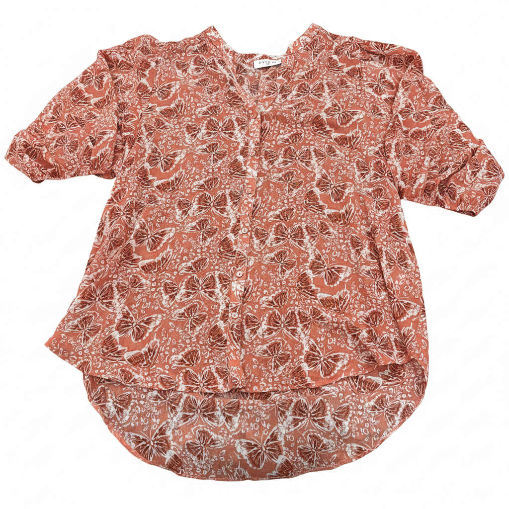 Rust orange butterfly print high-low blouse with button front by Ashir Studio, shown in a stylish photoshoot.