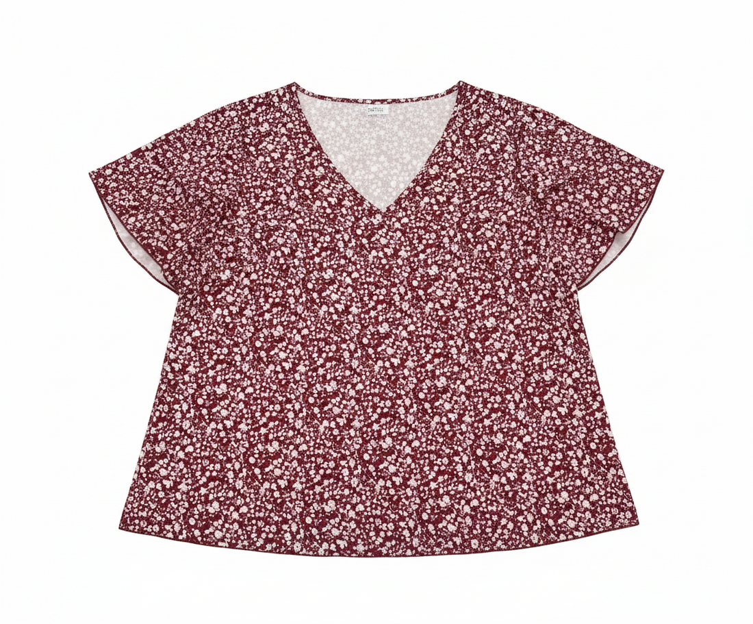 Floral V-neck flutter sleeve blouse by Ashir Studio, shown on a model with a light-colored background and delicate floral pattern.