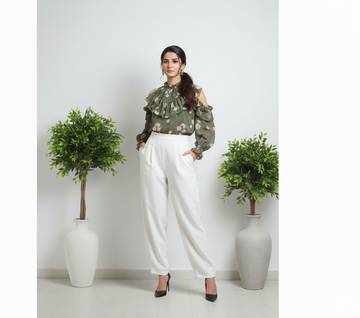 Model wearing Ashir Studio floral ruffle shirt with colorful floral pattern and ruffled details on the sleeves and collar.