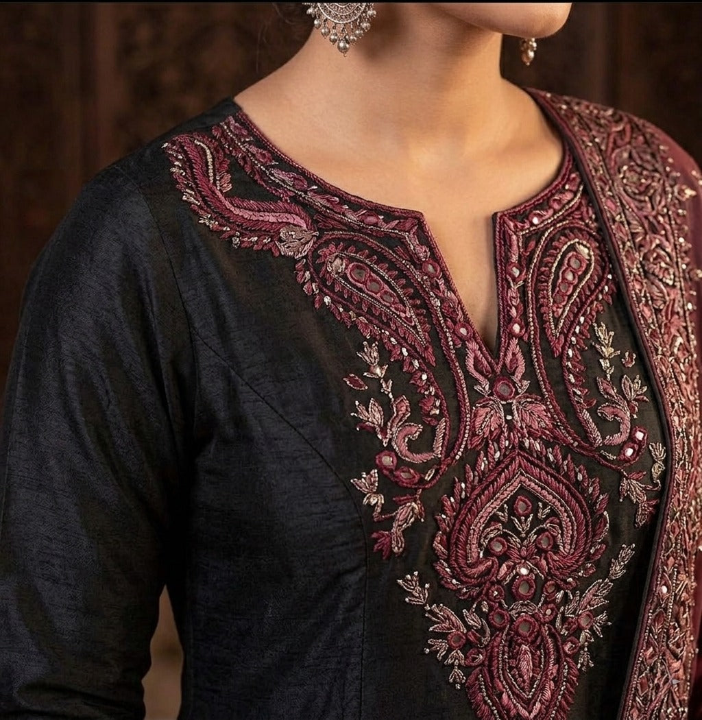 Maroon and gold embroidered black Anarkali gown by Ashir Studio with intricate detailing and flowing fabric.
