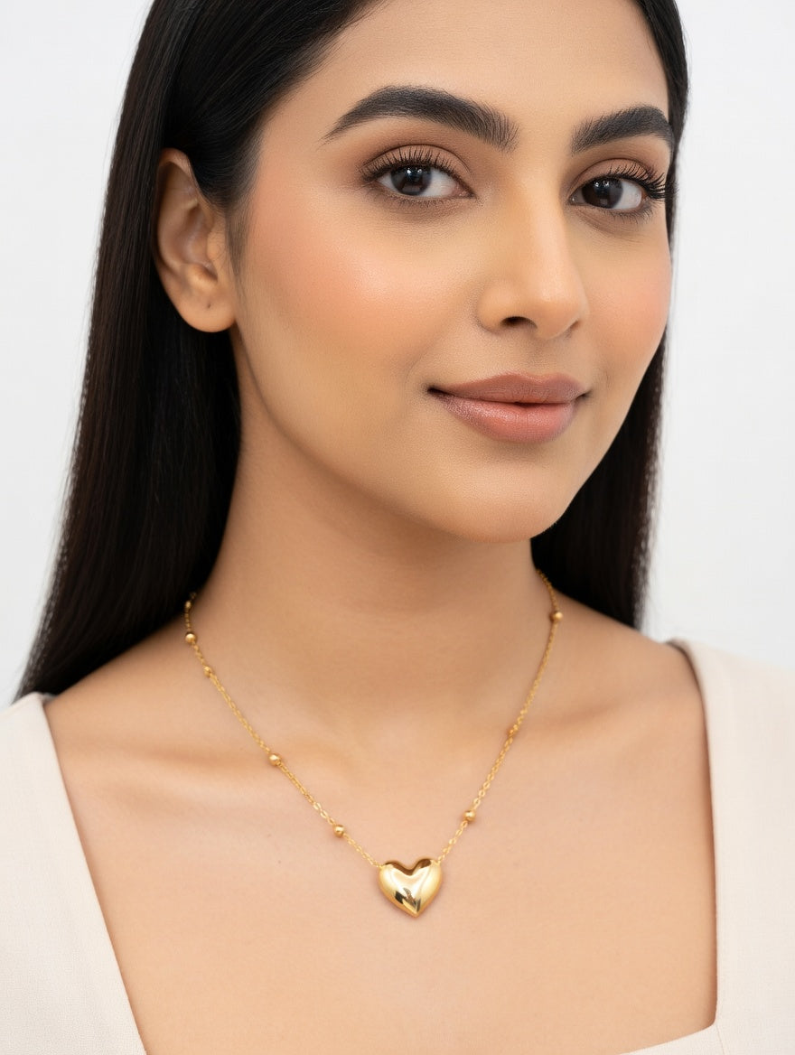 Heart-shaped gold necklace from Ashir Studio, featuring a delicate pendant on a fine chain, ideal for elegant jewelry attire.